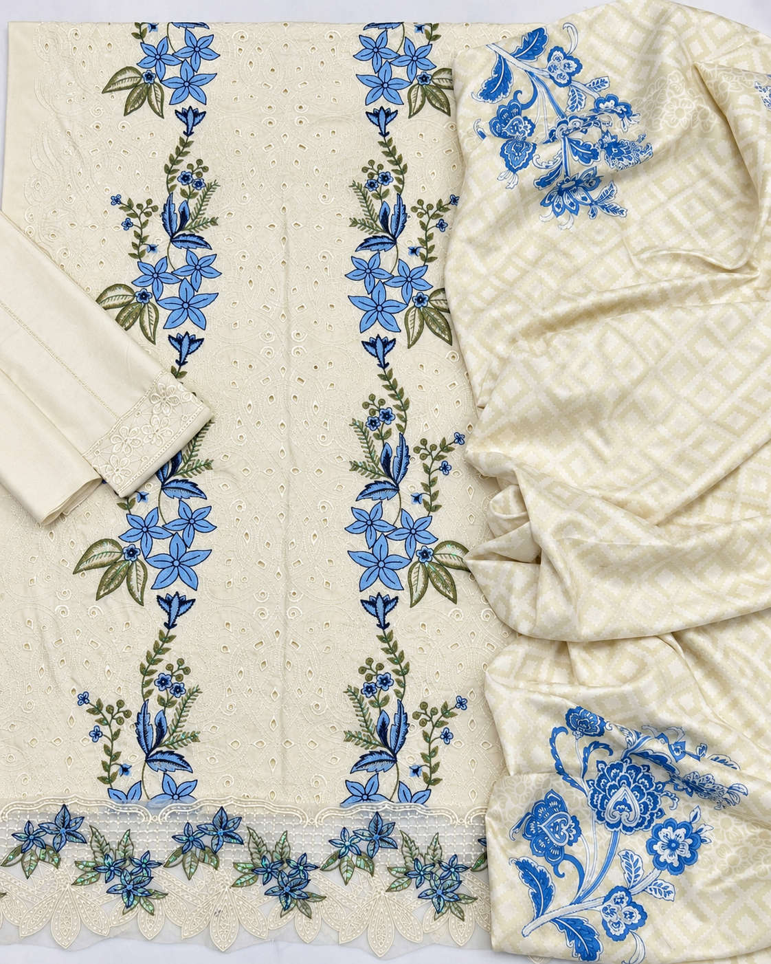 Cream Dhanak 3-piece embroidered women's suit with blue floral Chikankari-style embroidery, embroidered daman border, plain sleeves and trouser, and printed matching shawl, design K-711.