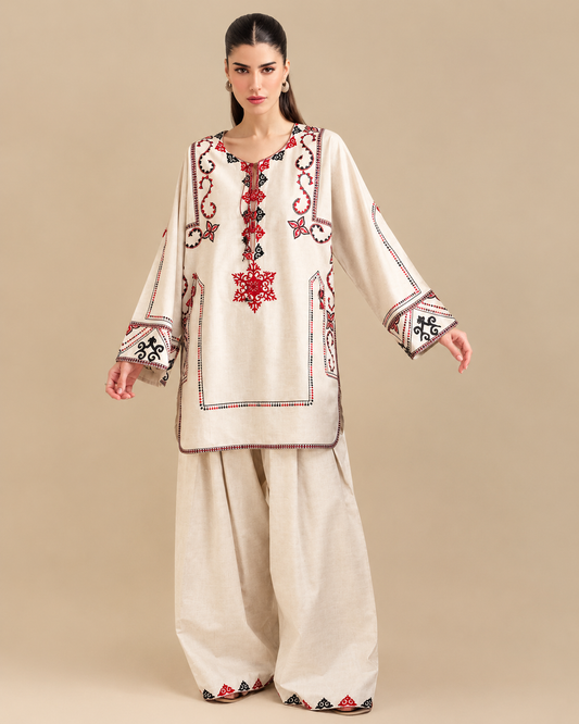 
Cream embroidered 2-piece Pakistani suit with red and black embroidery, front, sleeves and trouser details

